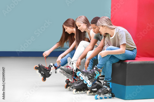 Group of teenagers putting ...