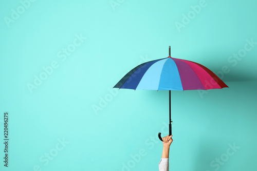Woman holding beautiful umbrella on color background with space for design