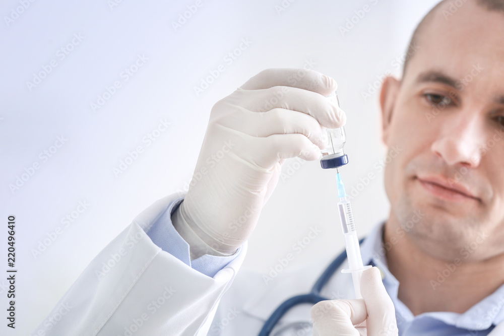 Doctor with syringe and vial, closeup. Vaccination day Doctor with syringe and vial, closeup. Vaccination day