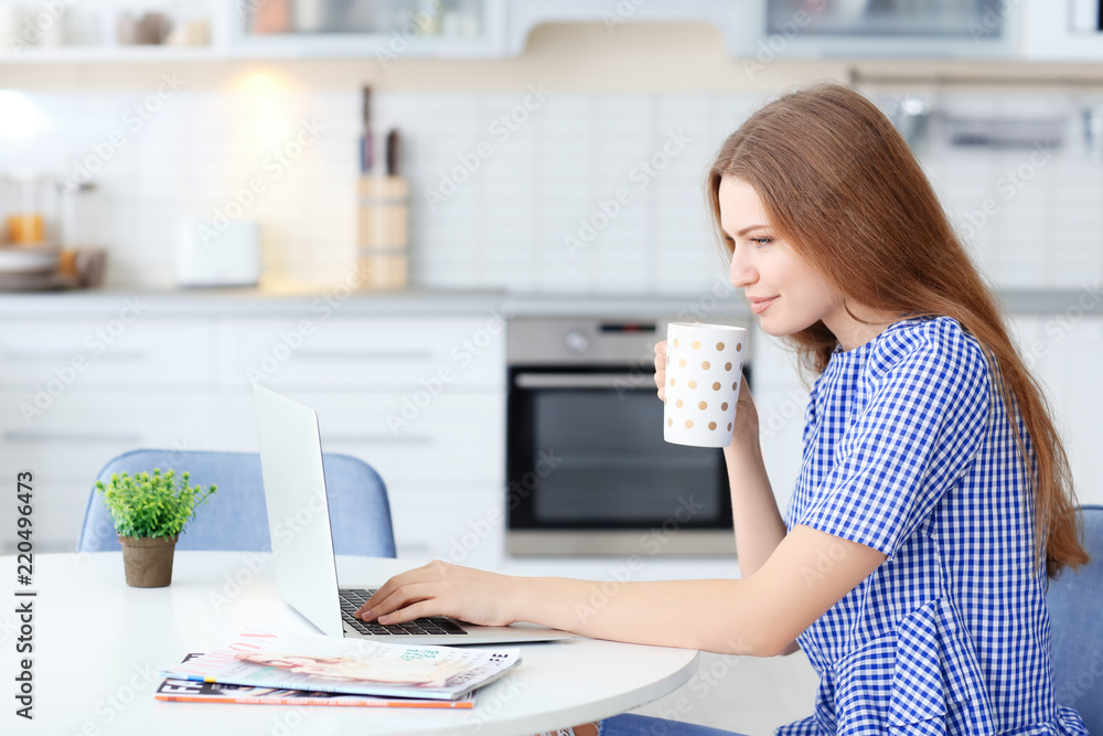 Young woman using laptop indoors Young woman using laptop indoors