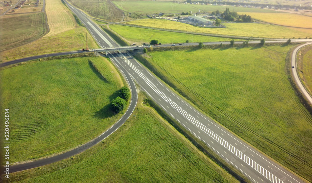 Aerial Top View of highway intersection junction summer morning with car.