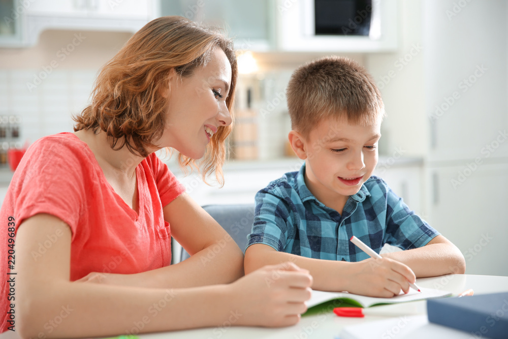 Little boy with mother doing homework at home Little boy with mother doing homework at home