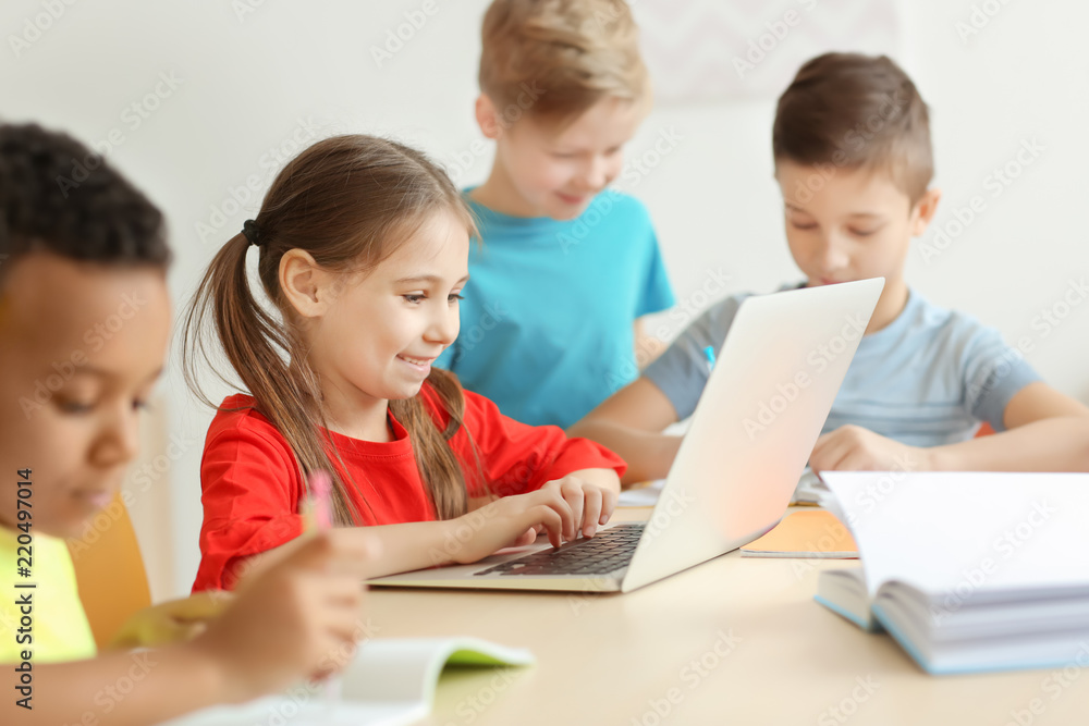 Cute children doing homework in classroom at school Cute children doing homework in classroom at school