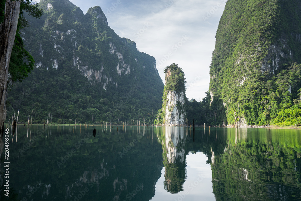 Morning mountain landscape and mist with mountains reflected in the water