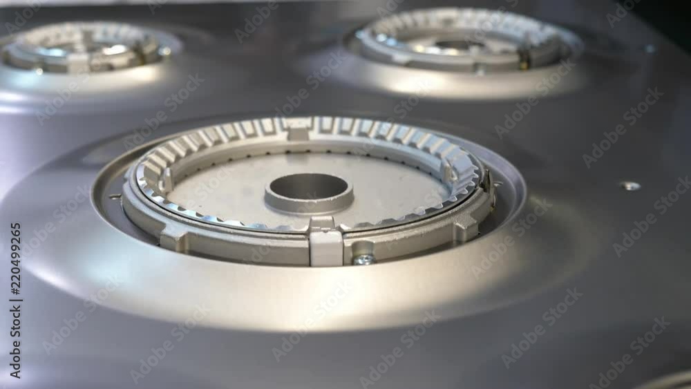 Kitchen hob factory, worker manually assemble components on a kitchen hob, close-up shot. Kitchen hob factory, worker manually assemble components on a kitchen hob, close-up shot.