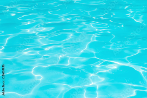 Wonderful blue and bright ripple water and surface in swimming pool, Beautiful motion gentle wave in pool for blue abstract or nature background