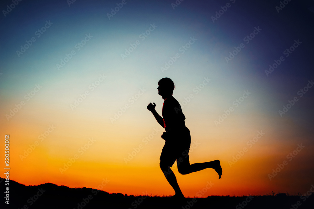 silhouette of man running outdoor cross-country at sunset silhouette of man running outdoor cross-country at sunset