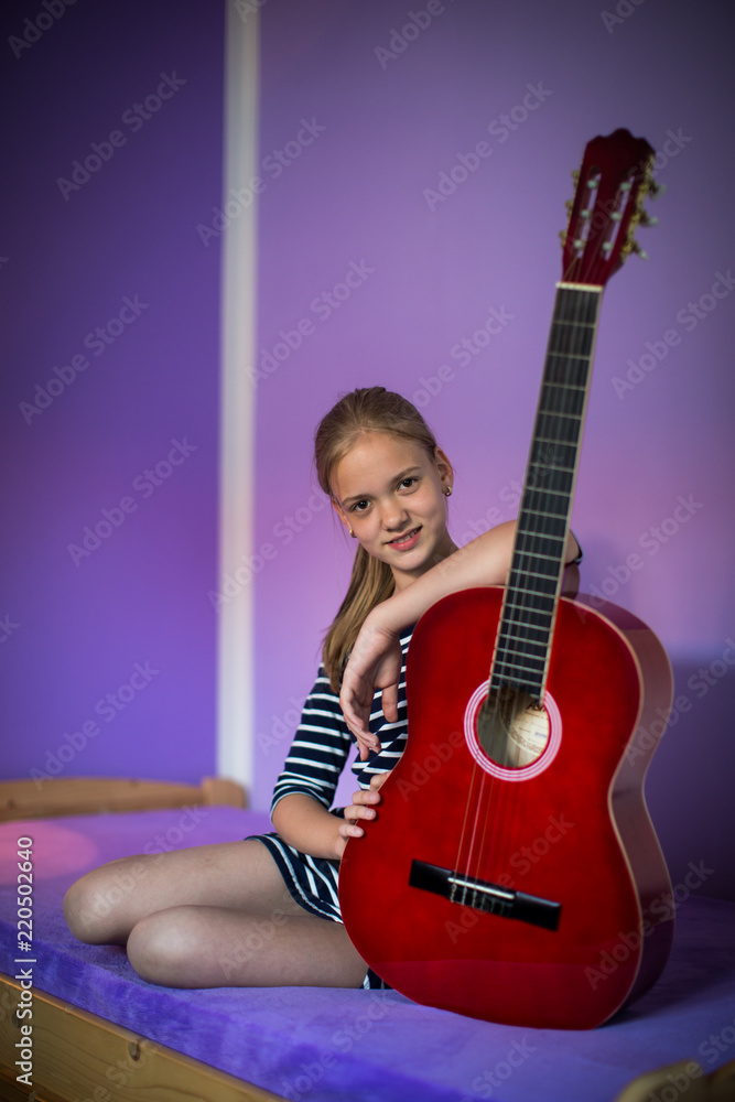 Fototapeta premium Teenage girl with her guitar in her lovely room