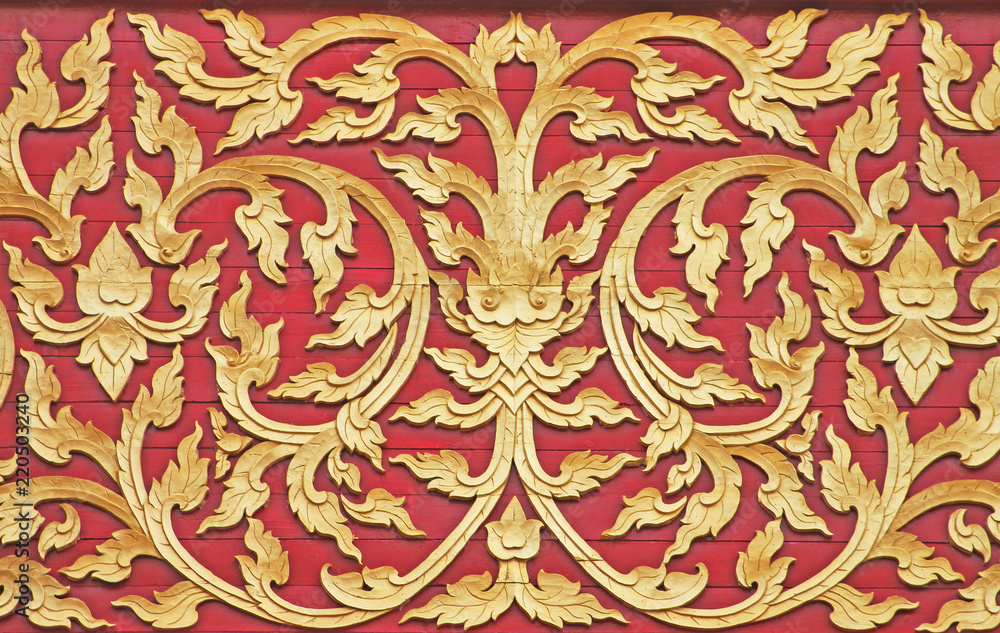 Gold flower patterns on red wooden wall background at temple