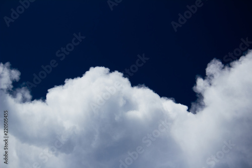 white cumulus cloud on dark blue sky move