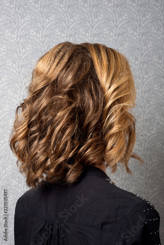Female hairstyle short locks on the head brown-haired back view close-up.