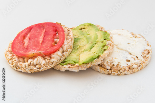 round crispbreads with tomatoes avocado and chees
