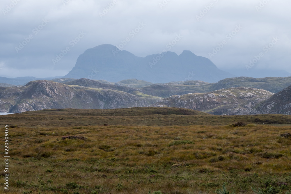 View of the Scottish Highlands near Lochinver, showing Mount Suilven in the background and heather in the foreground. View of the Scottish Highlands near Lochinver, showing Mount Suilven in the background and heather in the foreground.