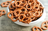 Hard Pretzels or Salted pretzels snack for party in white bowl on wooden floor.