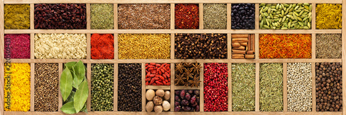 spices and herbs for cooking different dishes. seasoning in wooden box, background, top view.