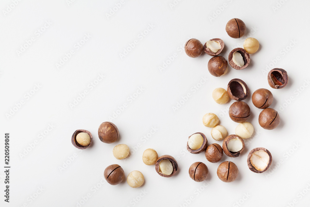 Organic macadamia nuts on white table top view. Organic macadamia nuts on white table top view.
