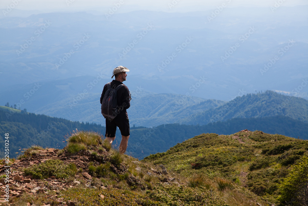 male hiker trekking in the mountains