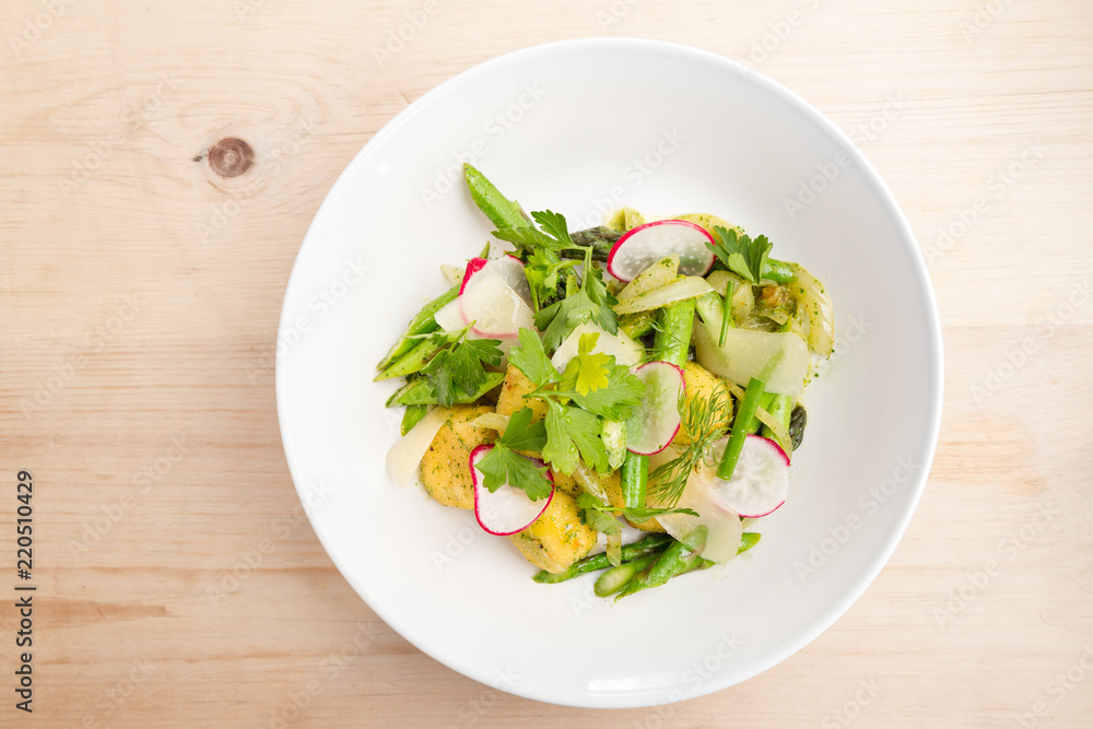 Plate of gnocchi with pesto with fresh local greens. Plate of gnocchi with pesto with fresh local greens.