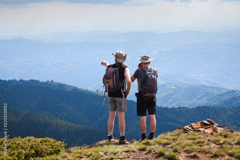 two male hikers trekking in the mountains