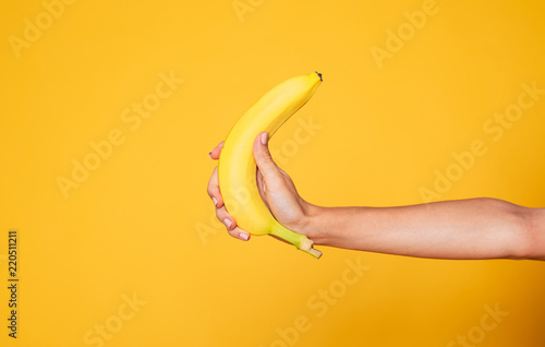 Female hand Holding Banana Fruit, Nutrition concept, human hand holding a ban...