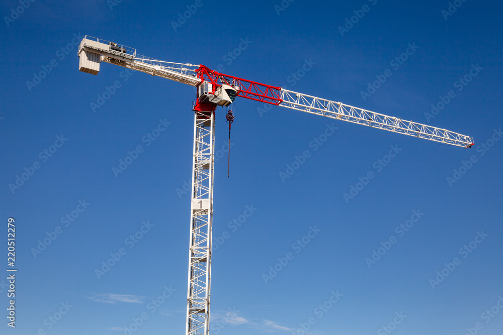 Tower crane against the blue sky - construstion concept Tower crane against the blue sky - construstion concept