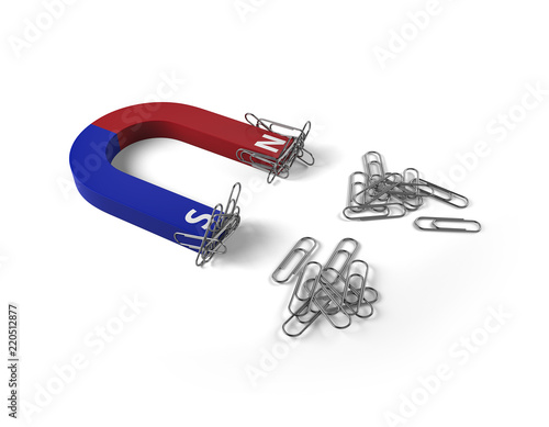 Magnet attracts paper clips on white background.