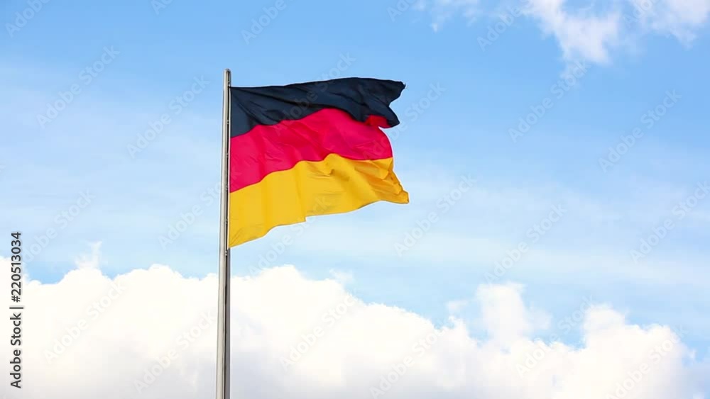 German flag waving with blue sky and clouds on background German flag waving with blue sky and clouds on background