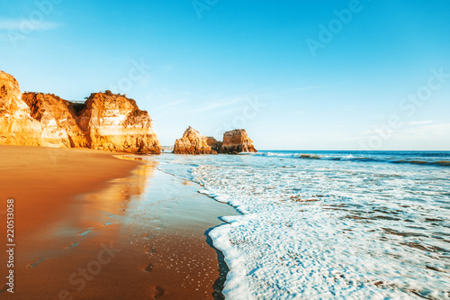 beautiful ocean landscape, the coast of Portugal, the Algarve, rocks on the sandy beach, a popular destination for travel in Europe photo