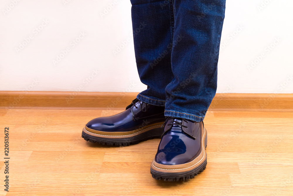 Man in elegant glossy blue shoes and classic jeans Man in elegant glossy blue shoes and classic jeans