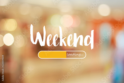 Weekend loading word on blurred in shopping mall background photo