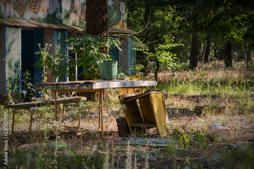 near an abandoned house is an old table
