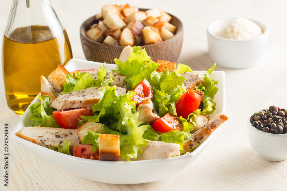 Fresh Greek salad with delicious ruccola, spinach, cabbage, arugula, feta cheese, red onion and cherry tomato on wooden background. Oil, salt and pepper. Healthy and diet food concept. Fresh Greek salad with delicious ruccola, spinach, cabbage, arugula, feta cheese, red onion and cherry tomato on wooden background. Oil, salt and pepper. Healthy and diet food concept.