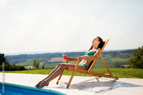 Sunbathing woman enjoying cocktail © NDABCREATIVITY