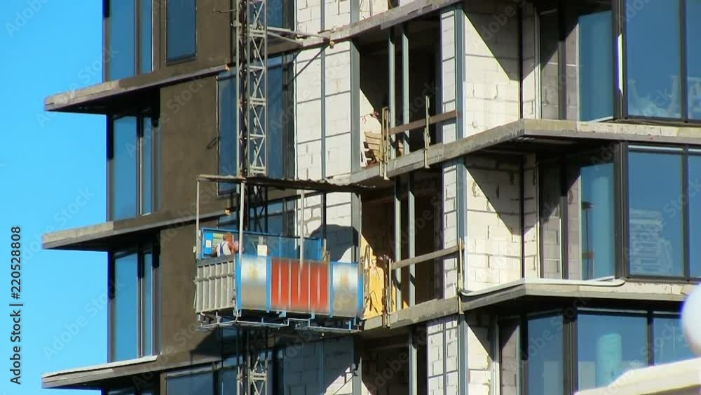 Construction, high-rise buildings, skyscrapers. The builder rises on the elevator. Construction, high-rise buildings, skyscrapers. The builder rises on the elevator.