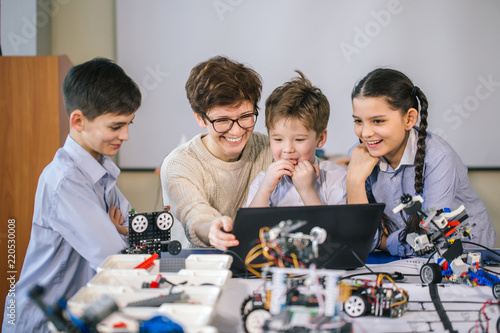 Smart kids with their mother learn programming using laptop at home, science children creativity study concept photo
