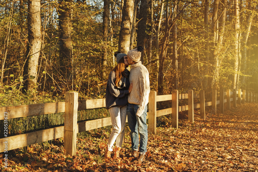 Fototapeta premium Young couple in the park at sunny autumn day