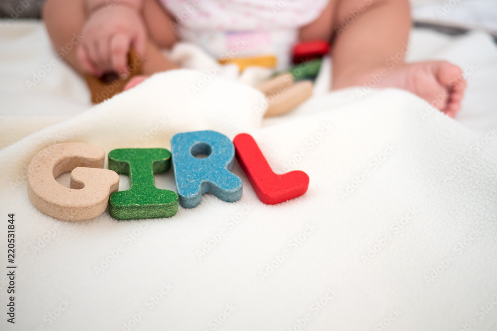 girl text wooden word on blanket with kid foot and copy space background girl text wooden word on blanket with kid foot and copy space background