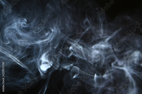 nice abstract contrast bright smoke against the heavy black background.