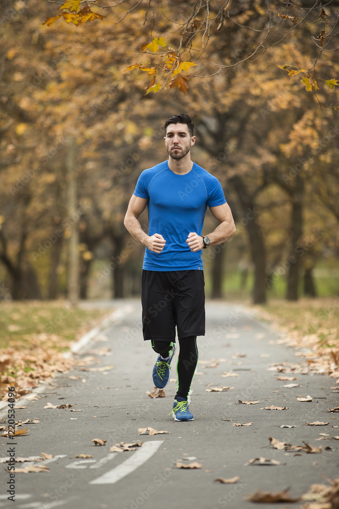 Athletic young man running in the nature. Healthy lifestyle