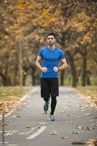 Athletic young man running in the nature. Healthy lifestyle