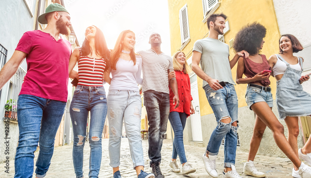 Young millennials friends walking in city old town center