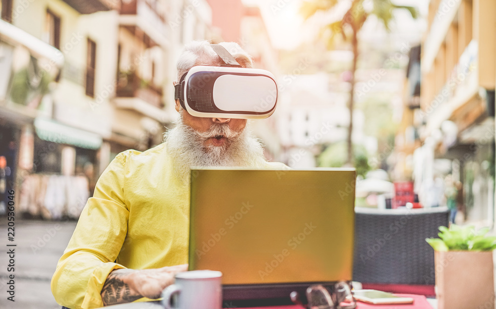 Bearded mature man wearing virtual reality goggles in bar outdoor Bearded mature man wearing virtual reality goggles in bar outdoor