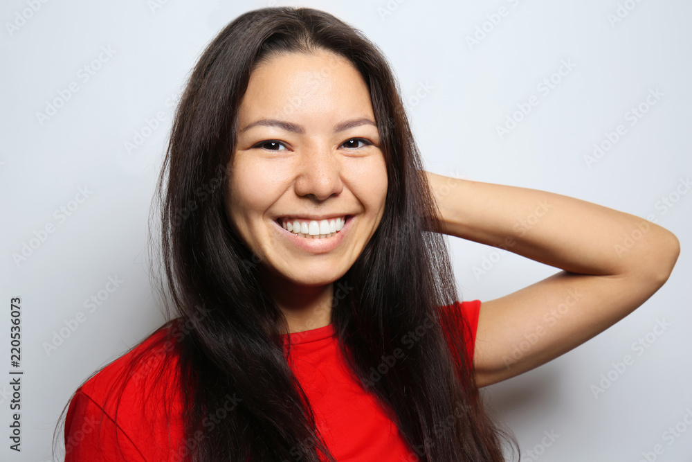 Attractive young woman posing on light background Attractive young woman posing on light background