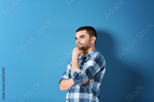 Portrait of handsome young man on color background