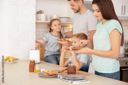 Happy family having breakfa...