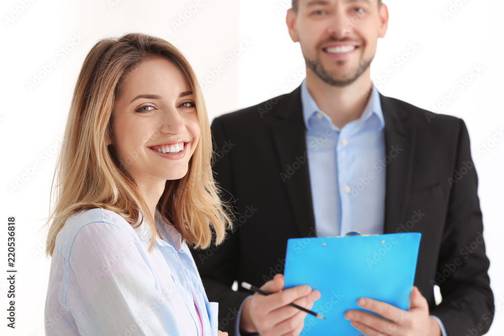 Businessman consulting young woman in office Businessman consulting young woman in office