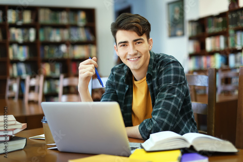 Student with laptop studyin...