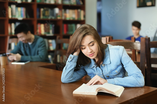 Pretty student with book st...