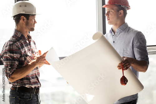 experienced architect is tranfering skills to a young one in the office building photo