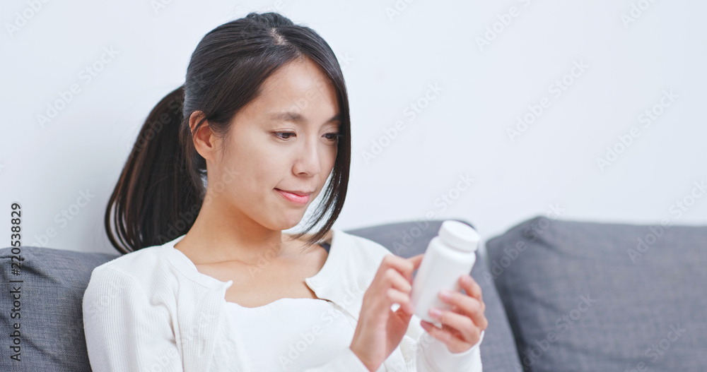 Woman check the ingredient of the medicine Woman check the ingredient of the medicine